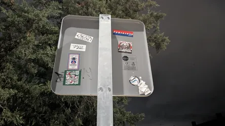 Street sticker This rectangular sticker features a black and white illustration of a group of stylized figures, possibly activists or members of a youth movement, standing together. They appear to be holding banners or flags. At the top of the sticker, the text 'PUK 92' is prominently displayed in a bold, blocky font. Below the figures, a banner or text reads 'LA JUVENTUD SIEMPRE VENCE' (Youth always wins) in a clear, uppercase font. The overall style is graphic and bold, conveying a message of unity and resilience.