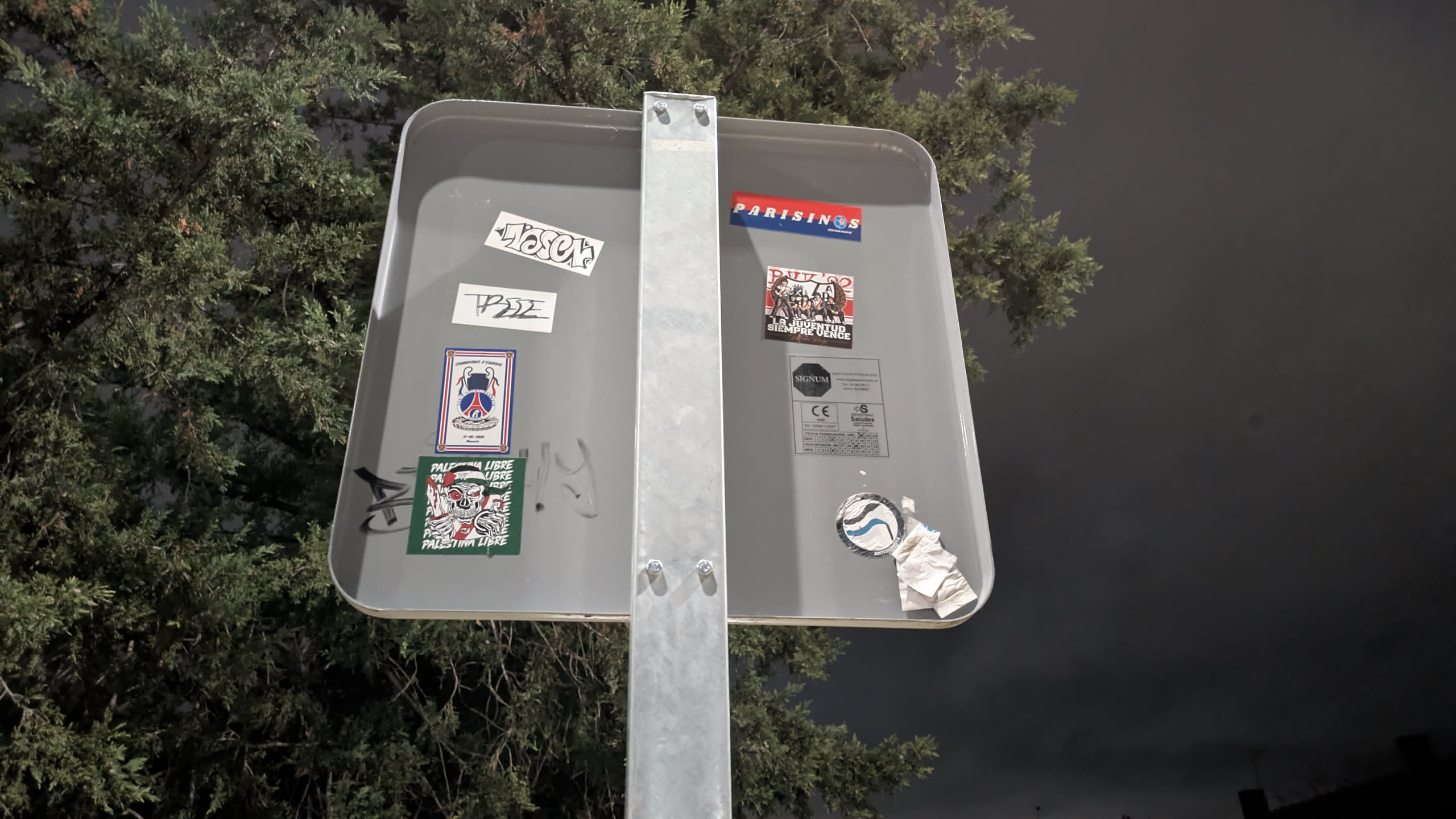 This rectangular sticker features a black and white illustration of a group of stylized figures, possibly activists or members of a youth movement, standing together. They appear to be holding banners or flags. At the top of the sticker, the text 'PUK 92' is prominently displayed in a bold, blocky font. Below the figures, a banner or text reads 'LA JUVENTUD SIEMPRE VENCE' (Youth always wins) in a clear, uppercase font. The overall style is graphic and bold, conveying a message of unity and resilience.