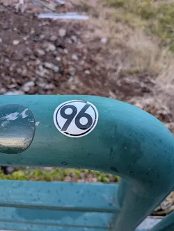 Street sticker Circular sticker on a green railing featuring the black and white '96' logo of the German football club Hannover 96.