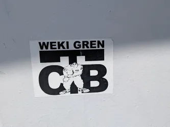 Street sticker A rectangular black and white sticker. It displays the text 'WEKI GREN' above large stylized letters 'C T B'. In the center stands a cartoon b-boy character wearing sneakers and a shirt labeled '650'.