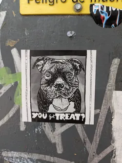 The sticker has a drawing of a dog with its tongue out. Below the dog, the sticker reads "YOU got TREAT?". The sticker appears to be black and white.