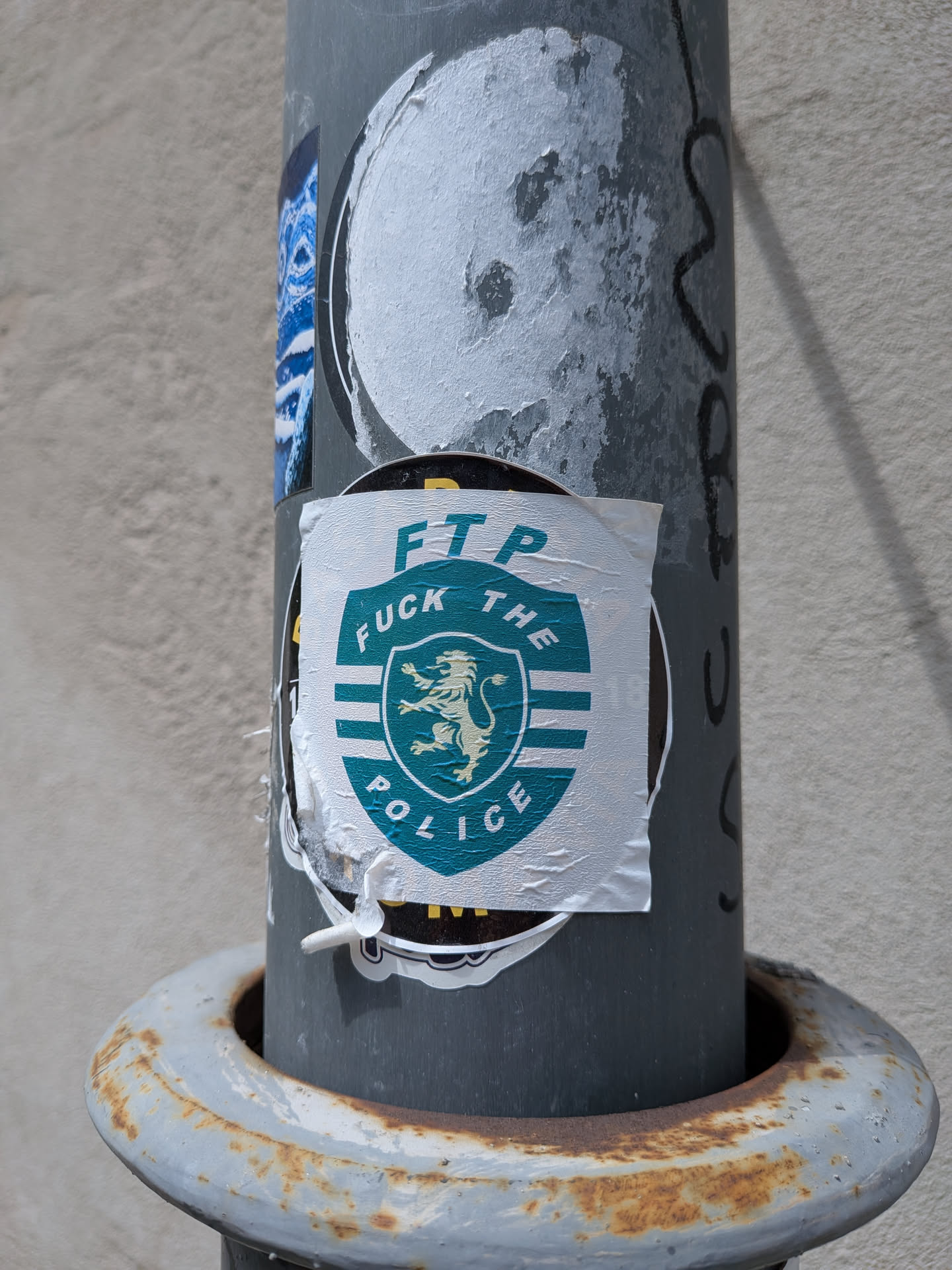 A white sticker featuring a green shield design based on the Sporting CP football club crest. It contains a gold rampant lion, white stripes, and the text 'FUCK THE POLICE' with 'FTP' written above.