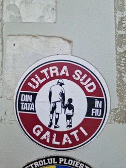 Street sticker Round sticker with a red border and white center. It features a black and white illustration of a father and son holding hands. The text on the sticker says "ULTRA SUD" at the top, "DIN TATA" on the left, "ÎN FIU" on the right, and "GALATI" at the bottom.