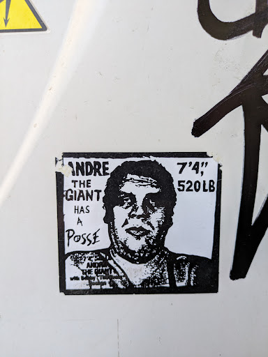 A black and white sticker featuring Andre the Giant with the text "ANDRE THE GIANT HAS A Posse" and "ANDRE THE GIANT with Bobby The Brain Heenan".
