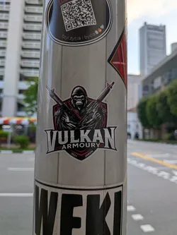 Street sticker A die-cut sticker depicting a fierce gorilla holding two crossed rifles against a red and black shield. The text 'VULKAN ARMOURY' is displayed below in a bold, stylized font, flanked by '2021' and 'JARVIN'.