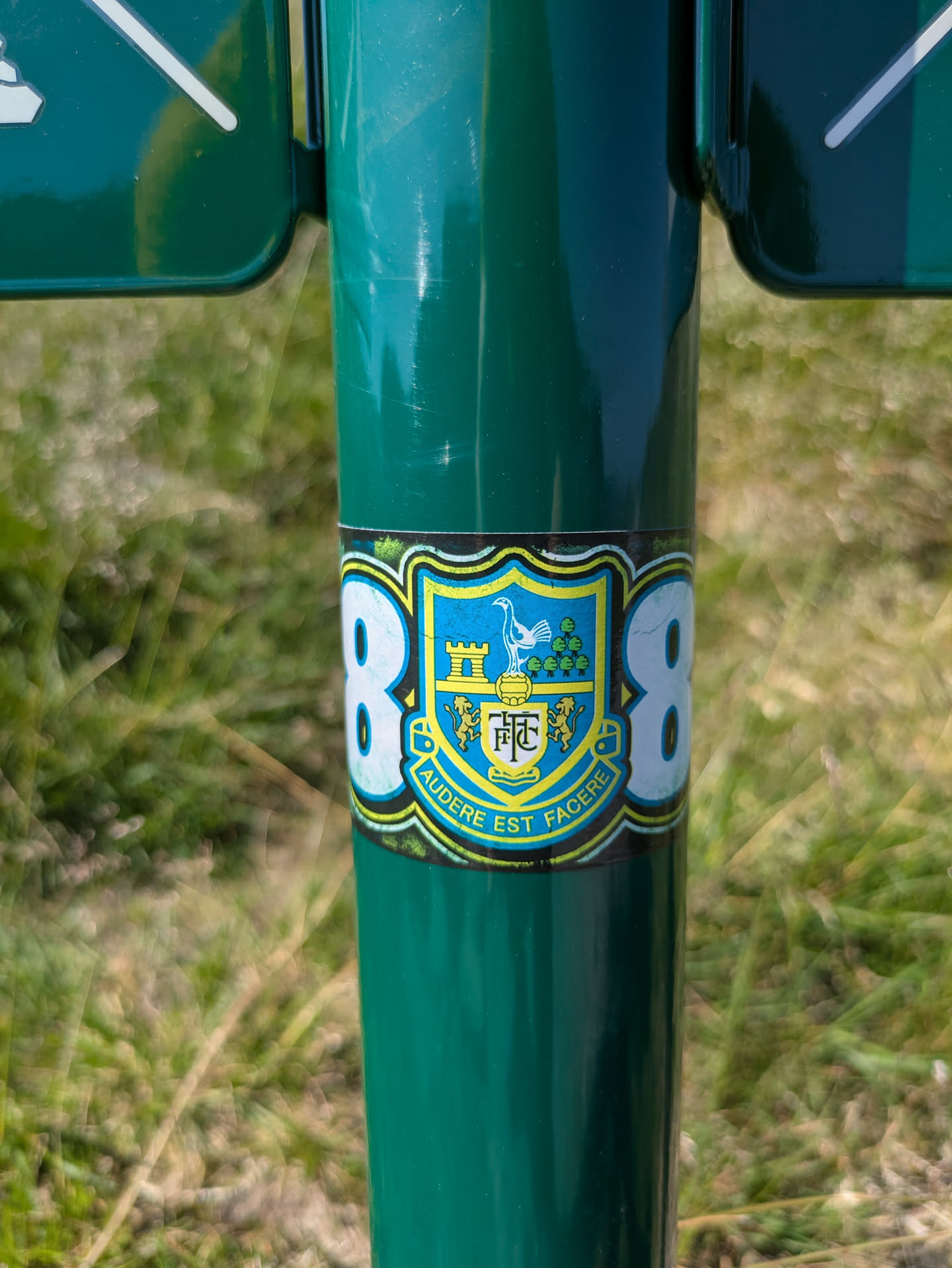 The sticker features the Sheffield Wednesday Football Club crest, which is a blue and yellow shield. Within the shield, there is a white owl perched on a football, flanked by a castle on the left and a cluster of trees on the right. Below the owl and football, the initials "SWFC" are prominently displayed on a banner, and below that, two lion-like figures are present. The bottom of the crest features a banner with the Latin motto "AUDERE EST FACERE". The entire crest is framed by a decorative border. On either side of the crest, large white numbers "88" are displayed.