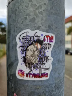 Street sticker A sticker featuring a stylized illustration of a person in a jacket, surrounded by abstract calligraphy-style text. The text includes the hashtag #TBO. The Instagram handle @TYOMELERS is visible in the bottom right corner. The sticker has a purple, gray, and white color scheme.