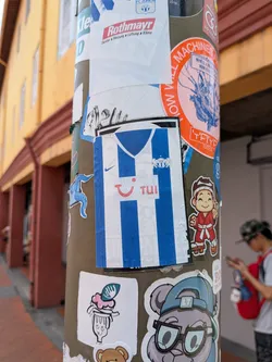 Street sticker Rectangular sticker depicting a blue and white striped football jersey. Features a blue collar, Nike swoosh, FC Zürich crest, and red TUI sponsor logo.