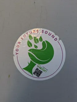Street sticker A round, white sticker with a stylized green hand/paw design with leaf-like fingers. The sticker reads "YOUR FUTURE SOUND" around the top circumference. Below the hand graphic, the name "Clarføn" is printed in small black text above a QR code.