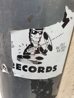 A black and white sticker with an illustration of a person with sunglasses using a drill on a record.  The word RECORDS is prominently displayed at the bottom. The text above states "BUT WE WANT GO POP".