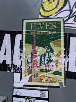 Street sticker A vintage-style travel poster sticker featuring a picturesque illustration of a church and surrounding landscape, with the text "ILVES TAMPERE-LAISTEN SEURA" visible. The sticker shows some signs of wear and tear, suggesting it may have been affixed outdoors for some time. At the bottom of the image there's a smaller sticker with a QR code and a website address.