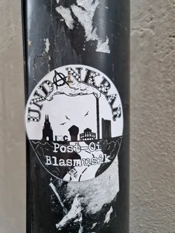 Black and white circular sticker with a city skyline, an anarchy symbol, and the text "Undankbar Post-Oi Blasmusik".