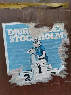 Street sticker A partially torn vintage sticker depicting a woman in a light blue sportswear sitting on the top spot of a winners podium holding a trophy. The text 'DJURGÅRDEN STOCKHOLM' is visible at the top of the sticker.  The sticker shows signs of wear and tear, indicating its age and exposure to the elements.