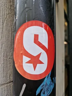A round, red sticker with a stylized white 'S' incorporating a red star.  The text 'www.spinnr.com' is visible at the top in a small font.