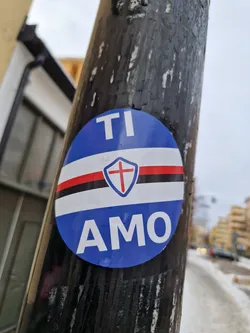 Street sticker A round blue and white sticker expressing love for Genoa CFC.  The sticker features the team's logo, a shield with a cross, and the words "TI AMO" (I love you in Italian).