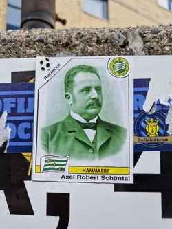 Street sticker A sticker featuring a portrait of Axel Robert Schönthal, a notable figure in Swedish football, with Hammarby IF branding. The sticker has a vintage design with a green-toned portrait and text information in a card-like format.