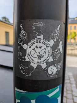 A square black sticker with a white illustration. It depicts a circular emblem reading 'GOUGE ONE YOUR LOCAL GRAFFITI BUDDY' with a central tag. Seven cartoon limbs radiate outward, holding a gun, fist, knife, Molotov, bomb, foot, and middle finger.