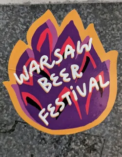 Street sticker The sticker is irregularly shaped, resembling a stylized hop cone or a flame, with jagged edges. Its primary colors are a deep purple in the center, outlined by a bright orange border. Within the purple area, there are abstract, organic shapes in lighter purple, red, and black, suggesting stylized leaves or fiery elements. The text 'WARSAW BEER FESTIVAL' is prominently displayed in a bold, white, hand-drawn style font, layered over these abstract shapes. The sticker appears to be adhered to a dark, speckled surface, possibly concrete or stone, and shows minor creases, indicating its physical nature.
