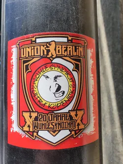 A sticker commemorating 20 years of Wuhlesyndikat, a Union Berlin fan group. The sticker features the Union Berlin logo, the Wuhlesyndikat logo, and the text "20 Jahre Wuhlesyndikat".