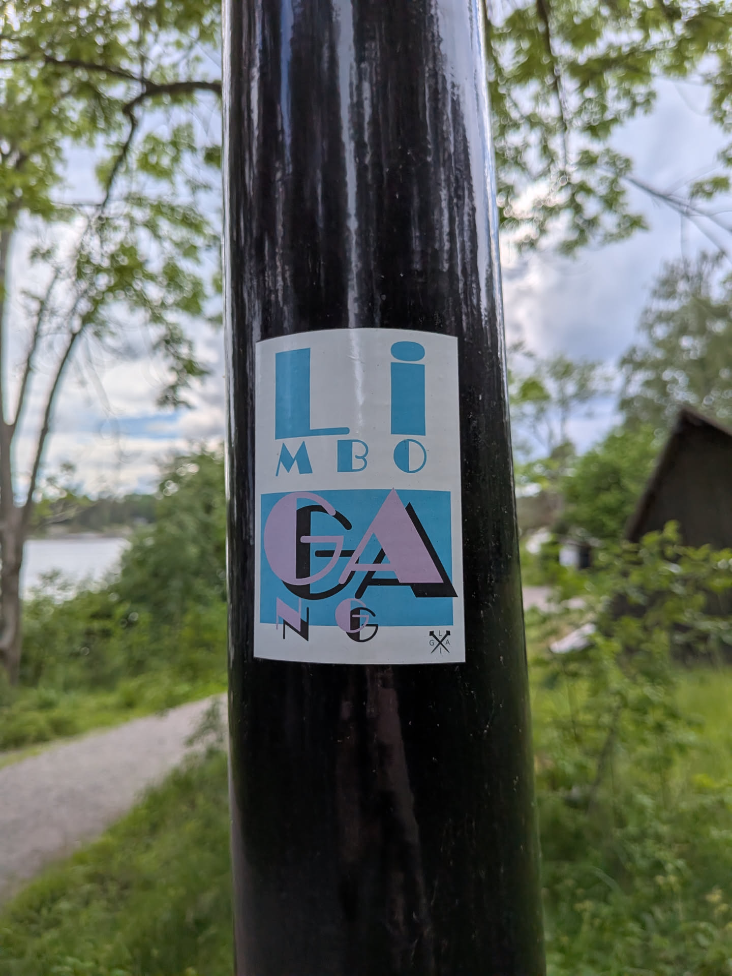 A rectangular white sticker with stylized typography. The top displays 'LIMBO' in light blue. The bottom features 'GANG' in pink and black over a blue background, with large 'G' and 'A' letters. A small crossed logo is in the bottom right.