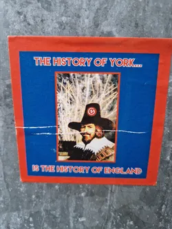 Street sticker A sticker featuring a portrait of a man in 17th-century attire, overlaid with text that reads "THE HISTORY OF YORK... IS THE HISTORY OF ENGLAND". The sticker has a red border and a blue background.