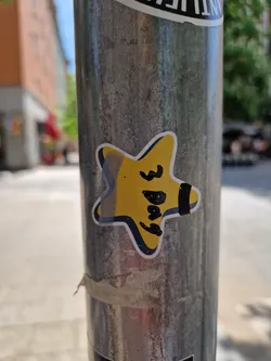 Street sticker A small, yellow star-shaped sticker with the words "3 Days" written on it in black marker. The sticker is affixed to a metal pole outdoors.  The style is simple and hand-drawn.