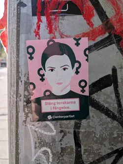 Street sticker A rectangular sticker depicting a stylized woman's portrait on a pink background patterned with black female symbols. The bottom features Swedish text in a pink box and the Centerpartiet logo on a dark green band.