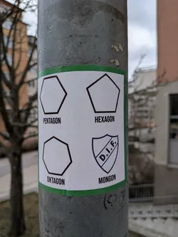 Street sticker A rectangular white sticker with a thin green border, affixed to a grey, textured metal pole. The sticker is divided into four quadrants, each featuring a black outline of a geometric shape or a logo, with a corresponding word in black text below it. The top-left shows a pentagon outline with 'PENTAGON'. The top-right shows a hexagon outline with 'HEXAGON'. The bottom-left shows an octagon outline with 'OKTAGON'. The bottom-right features a shield-shaped logo with the letters 'D.I.F.' inside, and the word 'MONGON' below it. The sticker appears slightly worn and adhered to the pole.