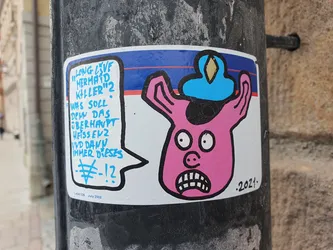 A pink pig-like creature with a blue hat is featured in this sticker. The sticker includes German text expressing a sarcastic or questioning tone.