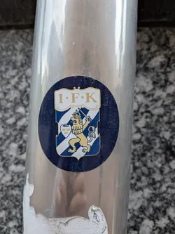Street sticker Circular dark blue sticker displaying the IFK Göteborg crest. Features a blue and white striped shield with a golden crowned lion holding a sword, topped by a white banner reading 'I·F·K'.
