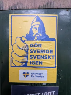 Street sticker A rectangular yellow sticker with blue graphics. It depicts a stylized Viking pointing forward, mimicking the Uncle Sam pose. The text reads 'GÖR SVERIGE SVENSKT IGEN'. Below, a white section displays the 'Alternativ för Sverige' party logo—a heart with the Swedish flag—and party name.