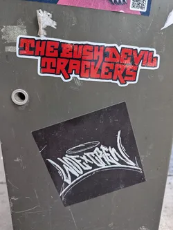 Street sticker A square black sticker, tilted slightly, featuring a stylized white graffiti handstyle tag that reads 'WESKCREW' with a halo drawn above it.