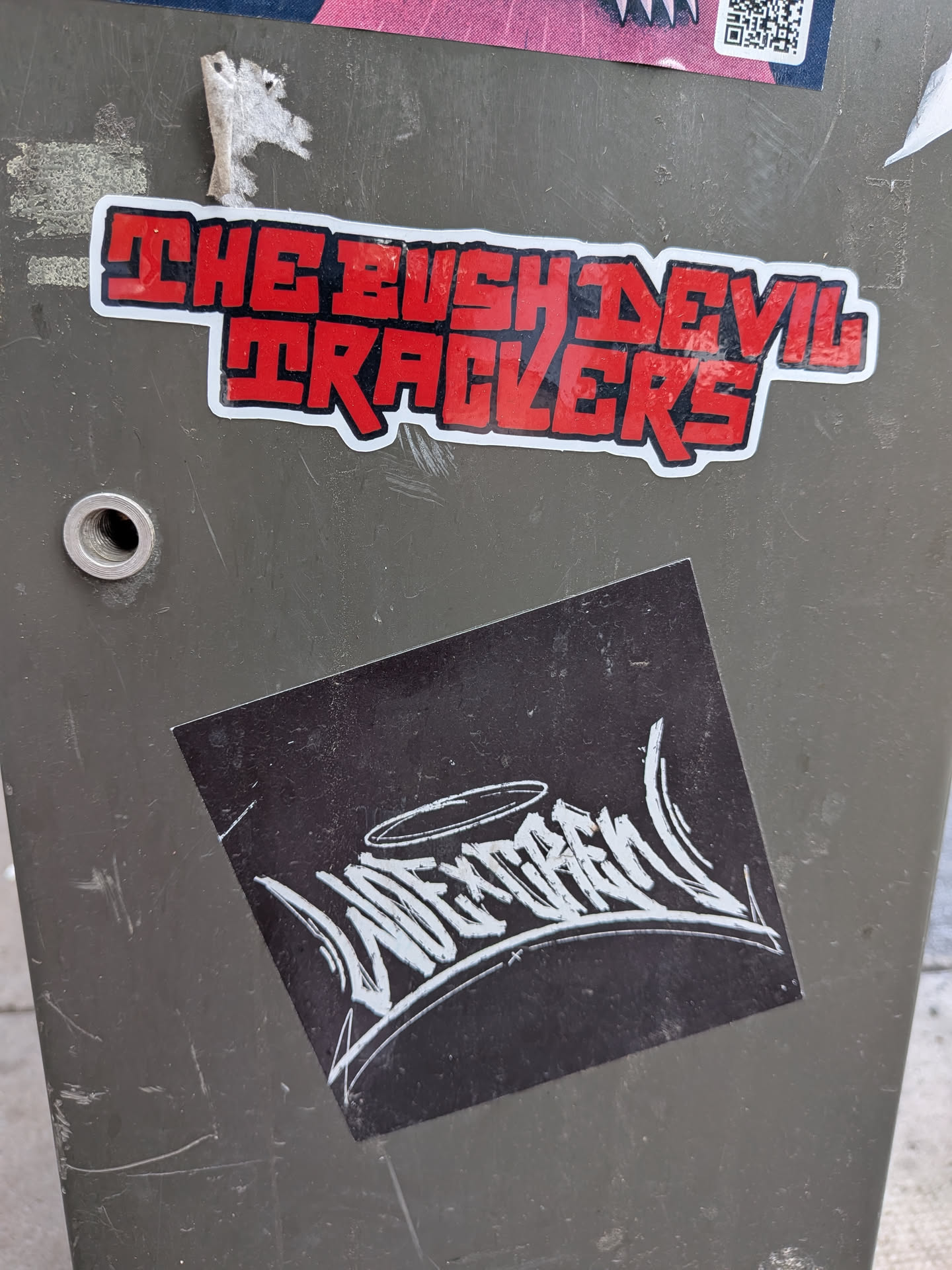 A square black sticker, tilted slightly, featuring a stylized white graffiti handstyle tag that reads 'WESKCREW' with a halo drawn above it.