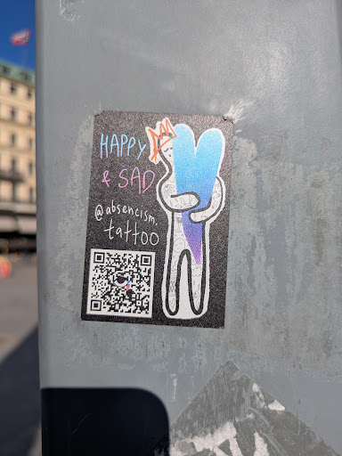 A sticker shows a cartoonish figure hugging a gradient blue and purple heart. The text "Happy & Sad" is written above the figure. Below the figure, the sticker shows the Instagram handle "@absencism.tattoo" and a QR code.