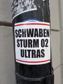Street sticker White rectangular sticker with red border stripes featuring bold black text reading 'SCHWABEN STURM 02 ULTRAS'.