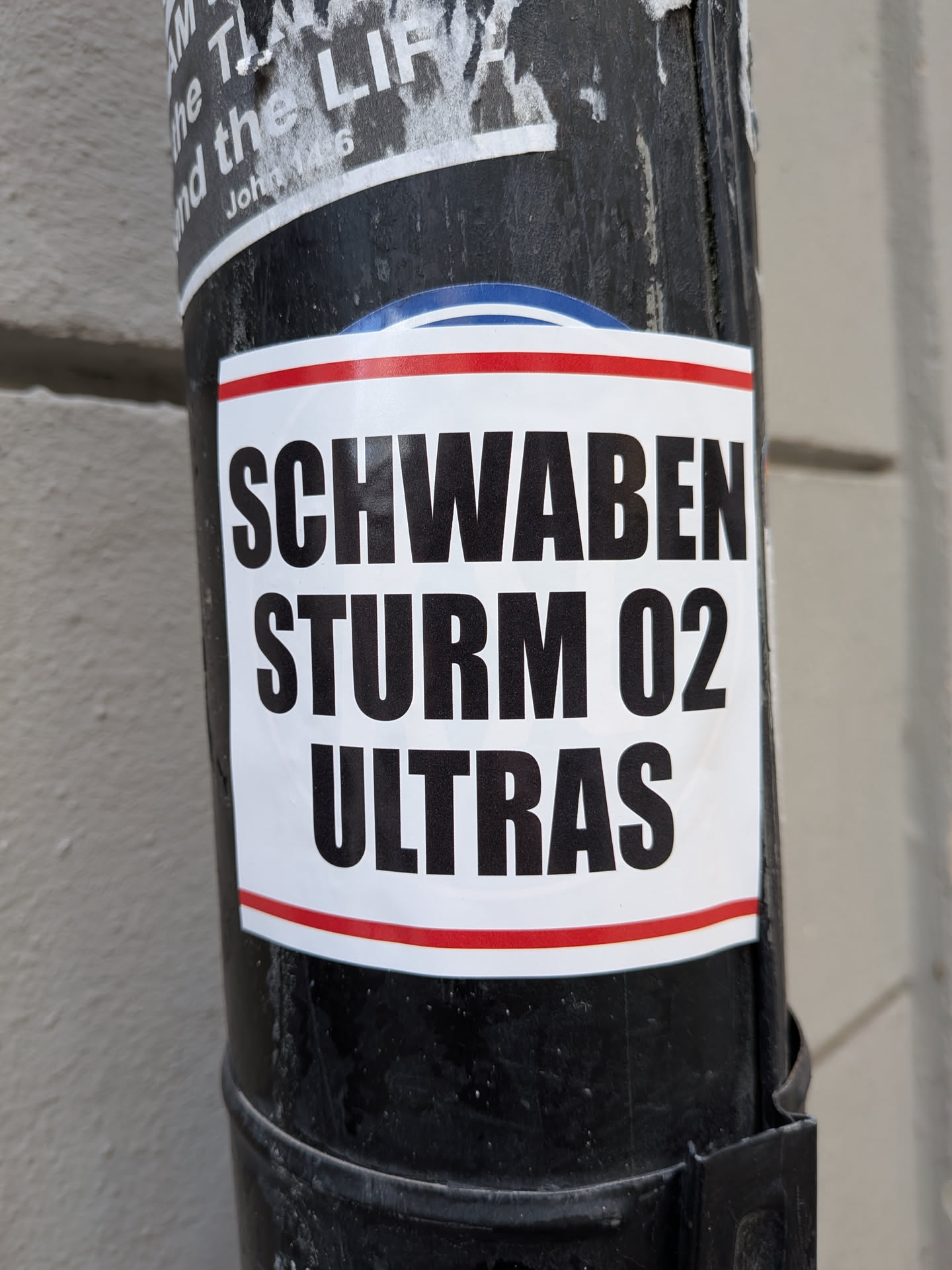 White rectangular sticker with red border stripes featuring bold black text reading 'SCHWABEN STURM 02 ULTRAS'.