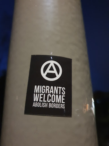 Street sticker MIGRANTS WELCOME ABOLISH BORDERS