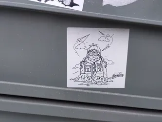 Street sticker A black and white drawing of a pilot in a thick jacket, goggles and helmet standing in a cloud. There are paper airplanes flying around him. 
