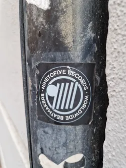 Street sticker A black and white circular sticker with the text "Ninetofive Records" and "Worldwide Beatmakers" arranged around a central logo. The logo features a circle with vertical lines and a smaller circle to the left.