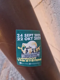 Street sticker Sticker promoting climate action with the dates of a potential event or protest.  It shows an illustration of people protesting. The text on the sticker says:
Dead Planet Soon, Act Now
System Change Not Climate Change