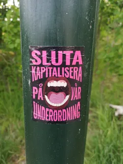 Street sticker A rectangular black sticker with bold pink Swedish text surrounding a central graphic of a wide-open, screaming mouth with white teeth and a pink tongue.