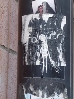 Black and white sticker with a drawing of a figure and the word "follower" written above it. The sticker is partially damaged and looks weathered.