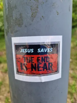 Street sticker A sticker featuring a religious message. The text on the sticker says "Jesus Saves" and "The End Is Near". The sticker has a distressed, vintage look.