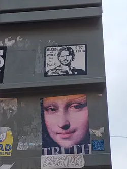 Street sticker A sticker featuring a stylized portrait of a man with the text "Alcide the Wolf has a pack", his height and weight, and a QR code. Below it is a sticker of Mona Lisa with the words "Truth Coasilucy"