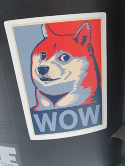 Street sticker A sticker featuring a Shiba Inu dog in the style of the iconic Hope poster. The dog's expression is one of slight surprise or wonder, and the word "WOW" is prominently displayed at the bottom.