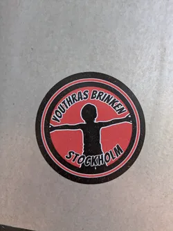 Street sticker This is a round sticker with a black and red design. The text 'YOUTHRAS BRINKEN' is written on the top part of the circle and 'STOCKHOLM' on the bottom part. In the center is a silhouette of a person with arms outstretched.