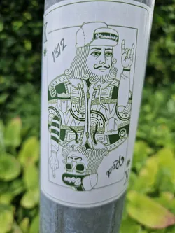 Street sticker This sticker features a unique illustration of the King of Spades, redesigned with a modern twist. He's wearing a trendy baseball cap and a stylish jacket. The green ink adds a nice touch. The sticker also displays the number 1312.