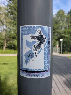 Street sticker A rectangular sticker on a pole featuring a blue patterned frame. Inside, a black-inked bird flies upward, leaving a blue silhouette of its form behind. The text 'BREAKING THE FOURTH WALL' is written at the bottom.
