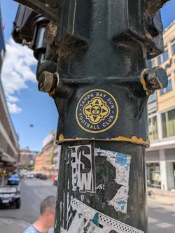 Street sticker A circular dark blue sticker with a yellow border. It features a stylized sun with a face in the center, surrounded by geometric patterns, and the text 'TAMPA BAY SUN FOOTBALL CLUB' written along the outer edge.
