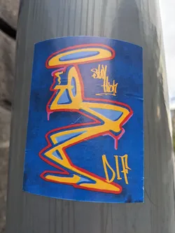 A sticker with an abstract design in yellow, red, and blue on a dark blue background. The text "Stay High" and a tag "DIP" are visible. 